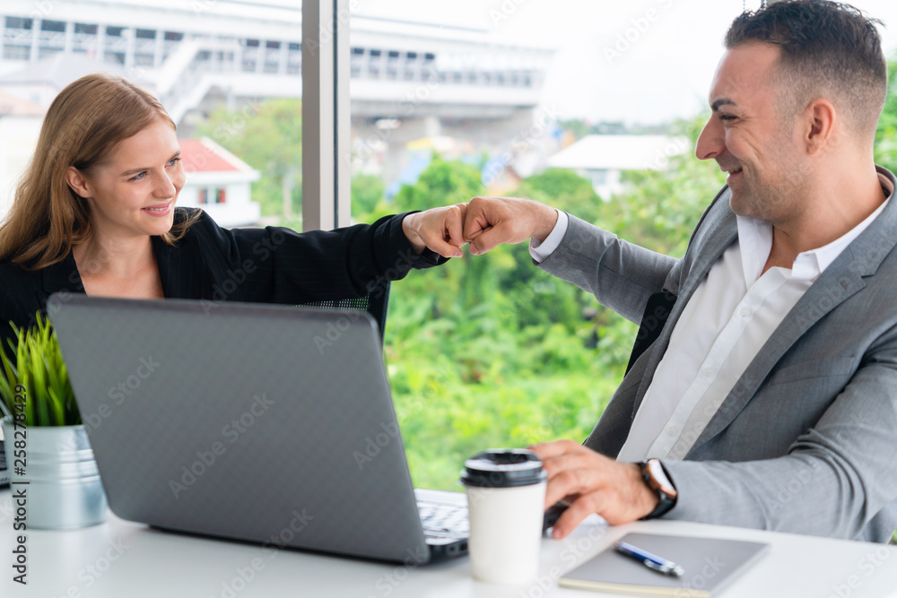 Success business partner - Businesswoman and businessman celebrating together in modern workplace of