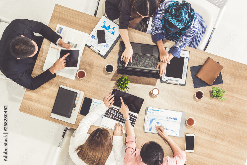 Top view of businessman executive in group meeting with other businessmen and businesswomen in moder