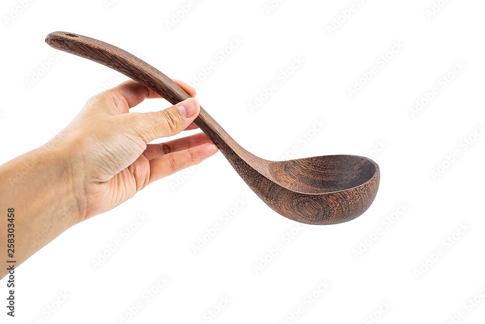 Hand holding empty wooden soup spoon on white background