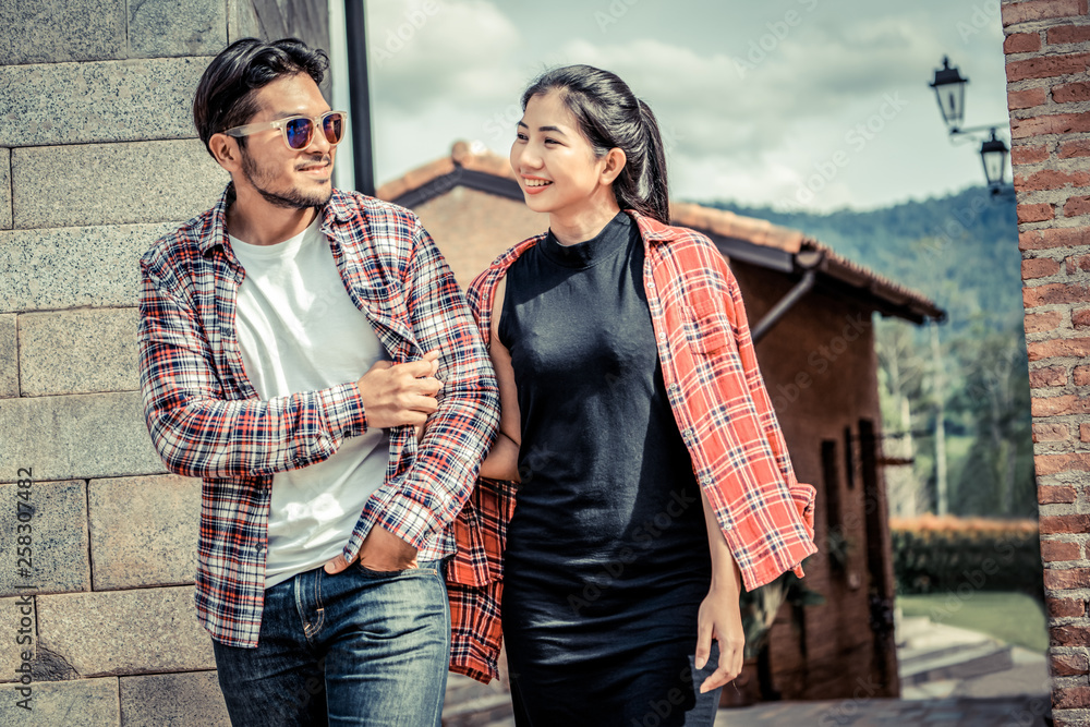 Happy young couple walking on the street in old town. Travel and dating concept.