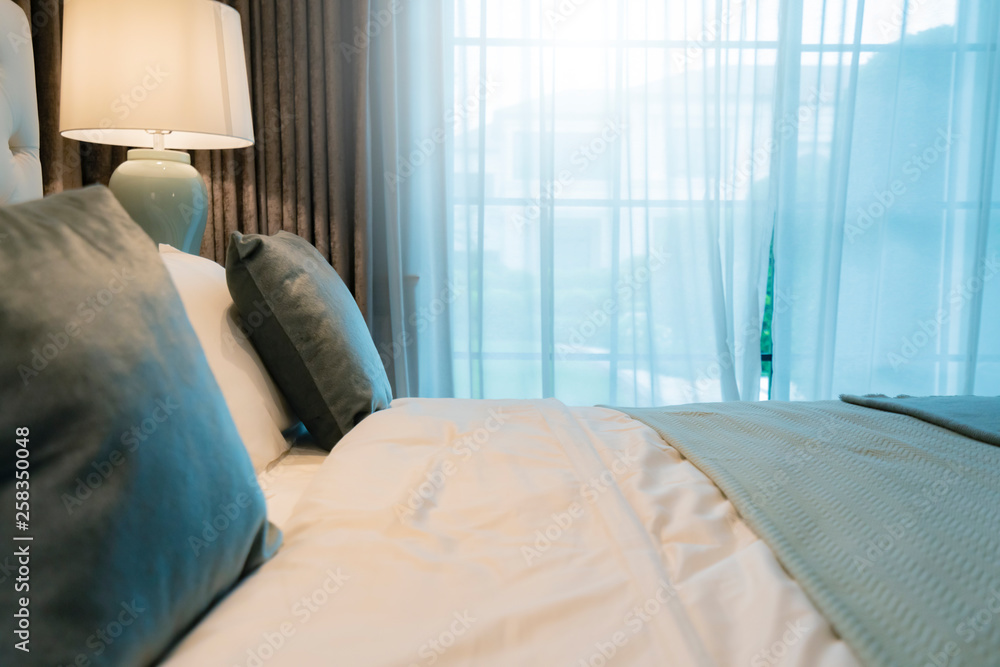 Bed maid-up with clean white pillows and bed sheets in beauty bedroom. Close-up. interior background