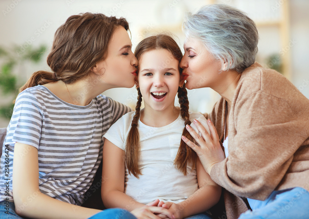 family three generations  grandmother, mother and child play and laugh at home.