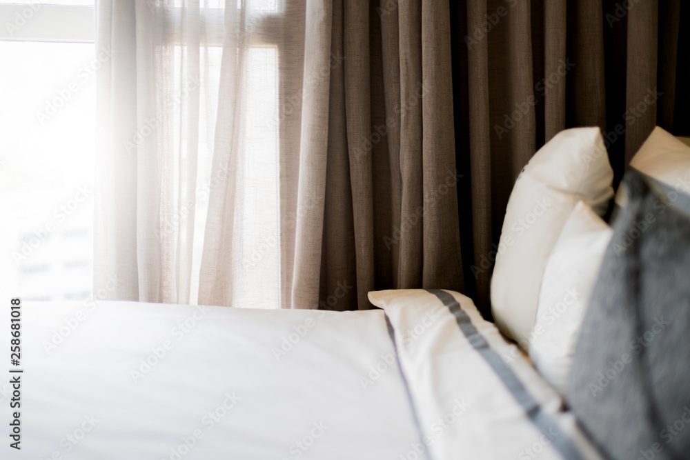 Bed maid-up with clean white pillows and bed sheets in beauty bedroom. Close-up. interior background