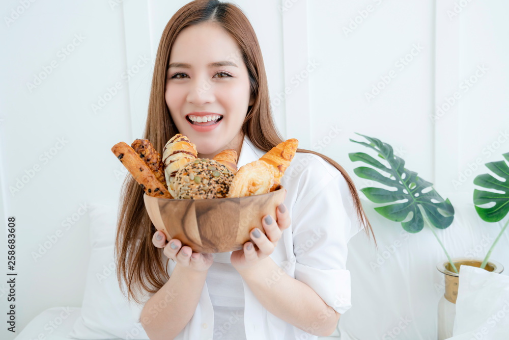 healthy ideas concept portrait of beautiful attractive asian woman hand hold bowl of bread with happ