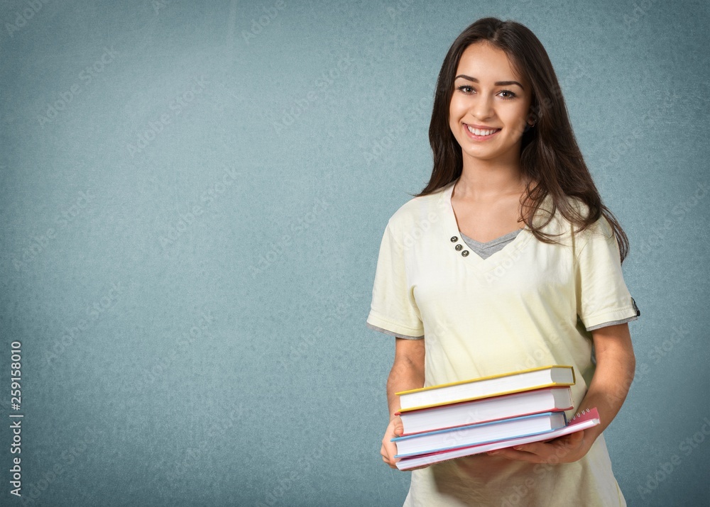 Young female student reading books