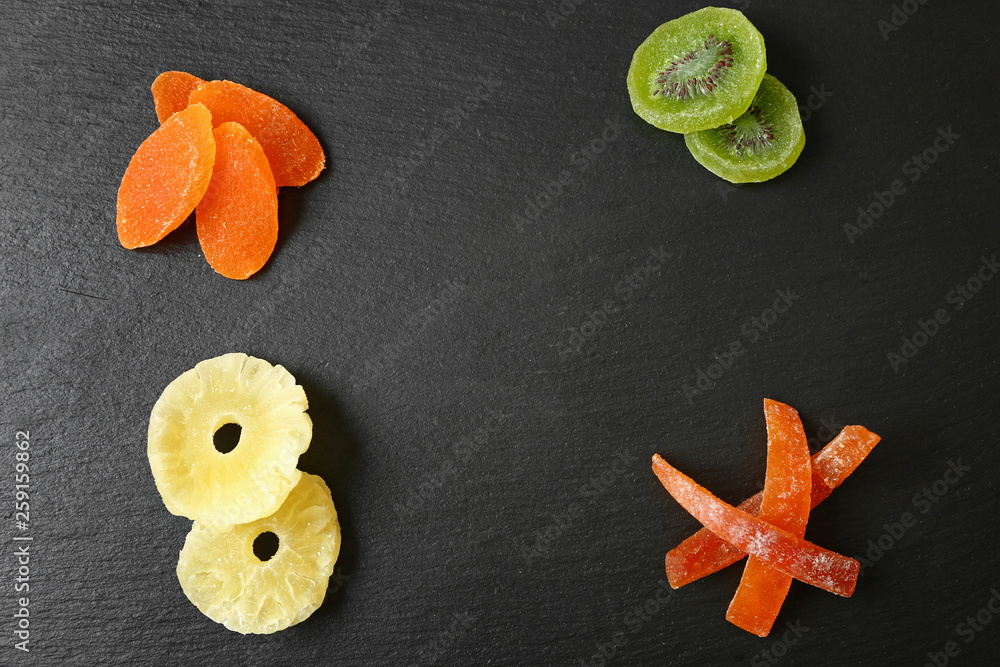 Tasty dried fruits on dark background