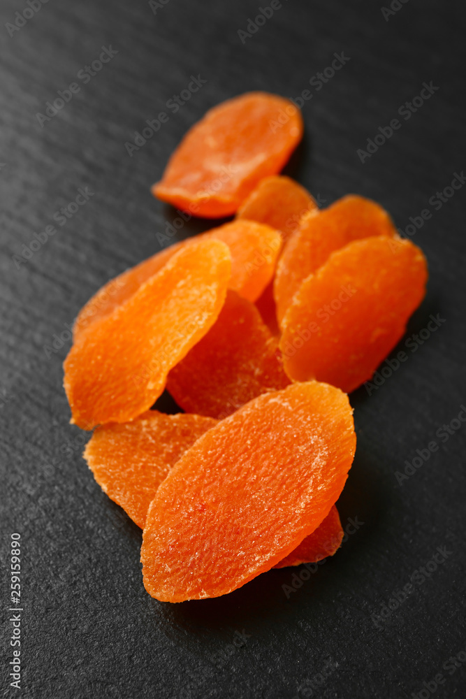 Tasty dried mango on dark background