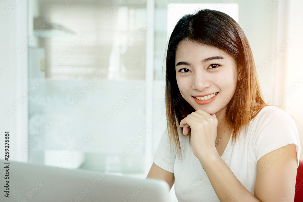 Young asian girl is freelancer with her private business at home office, working with laptop, coffee