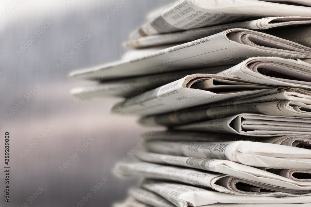 Pile of newspapers on white background