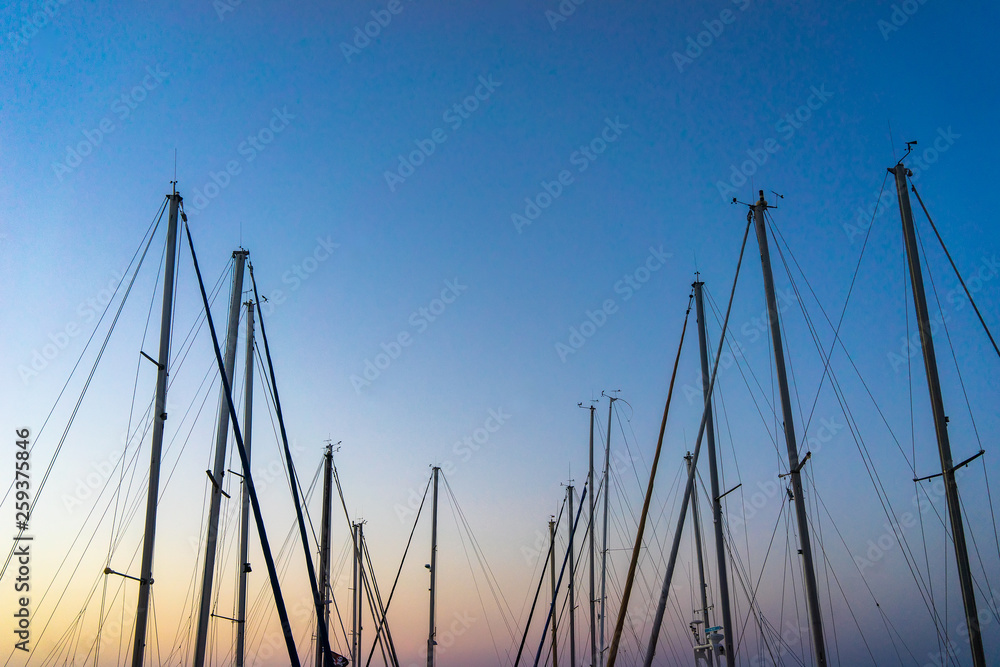 The evening sun and yacht mast silhouette