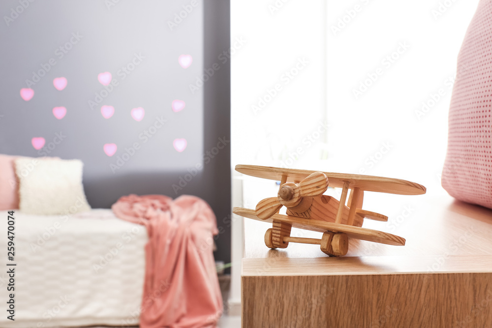 Toy airplane on table in kids room