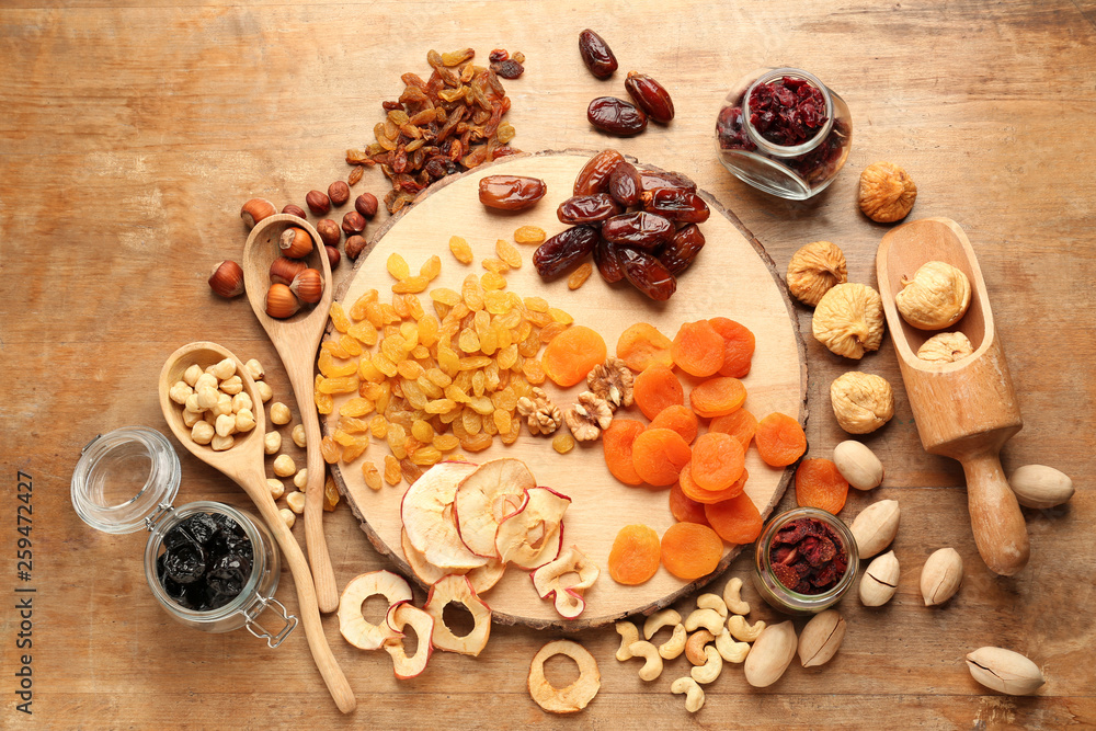 Assortment of tasty dried fruits and nuts on wooden table