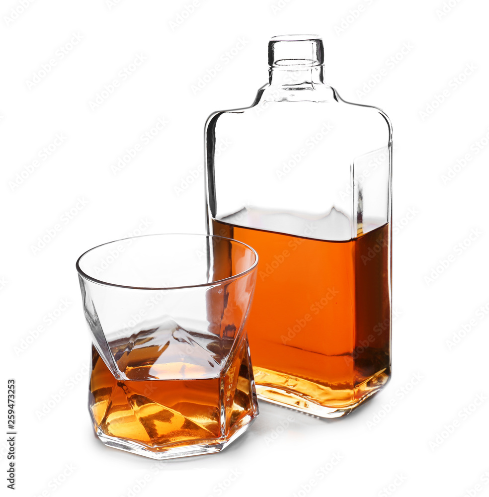 Bottle and glass of whiskey on white background