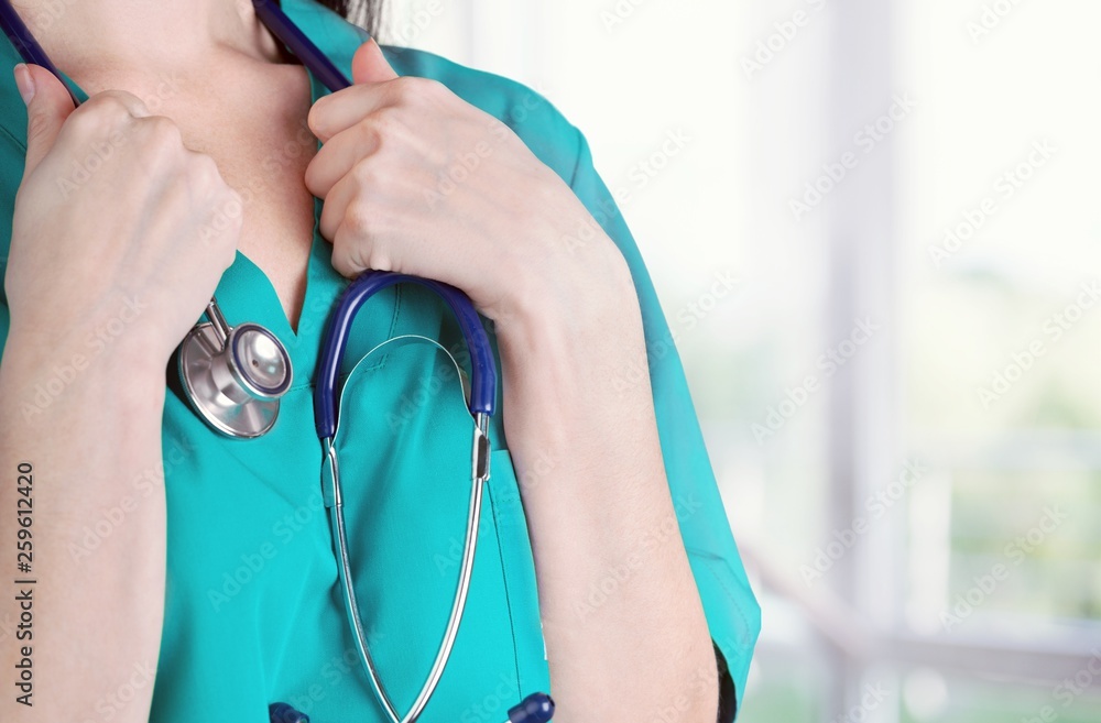 Young male doctor examining x-ray on white