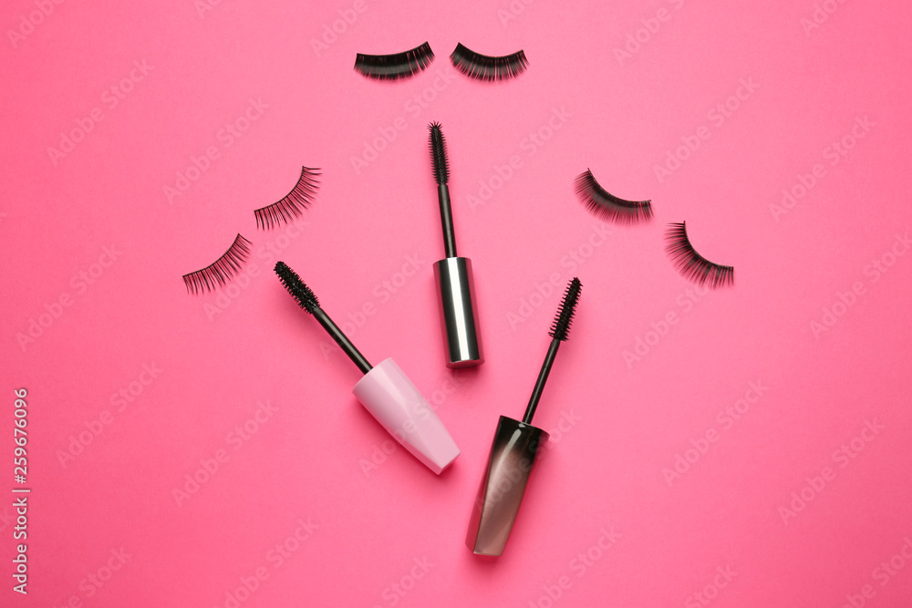 Mascara with false eyelashes on color background