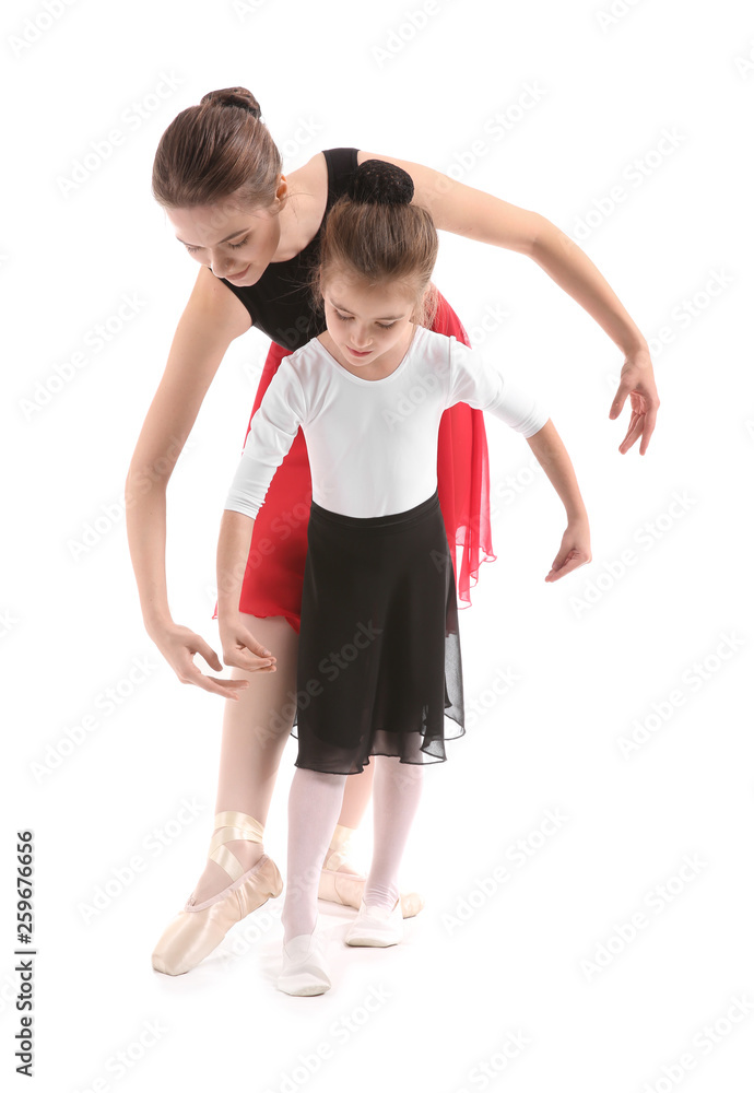 Little ballerina training with coach against white background