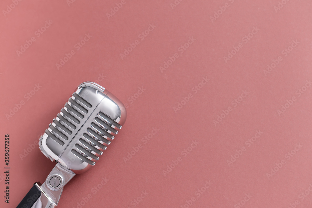 Retro microphone on color background