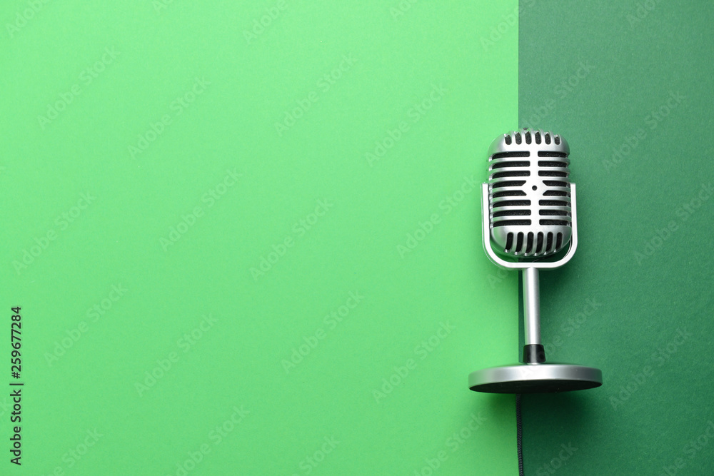 Retro microphone on color background