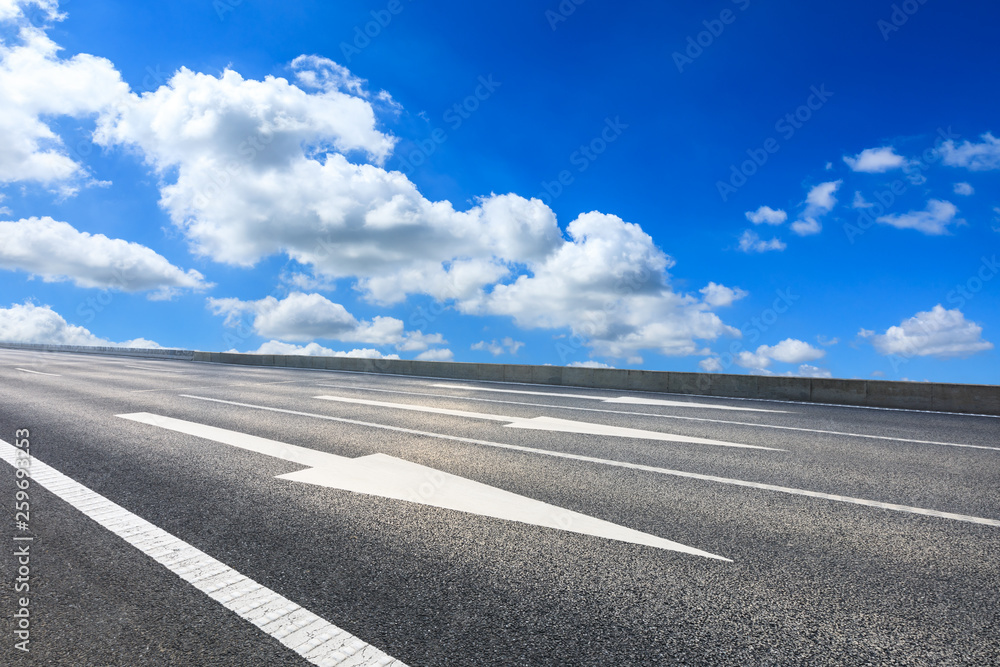 Empty asphalt road and blue sky with white clouds scene