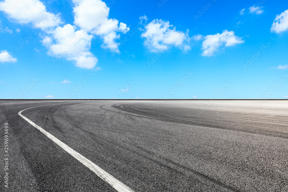 Asphalt race track ground and beautiful sky clouds scene