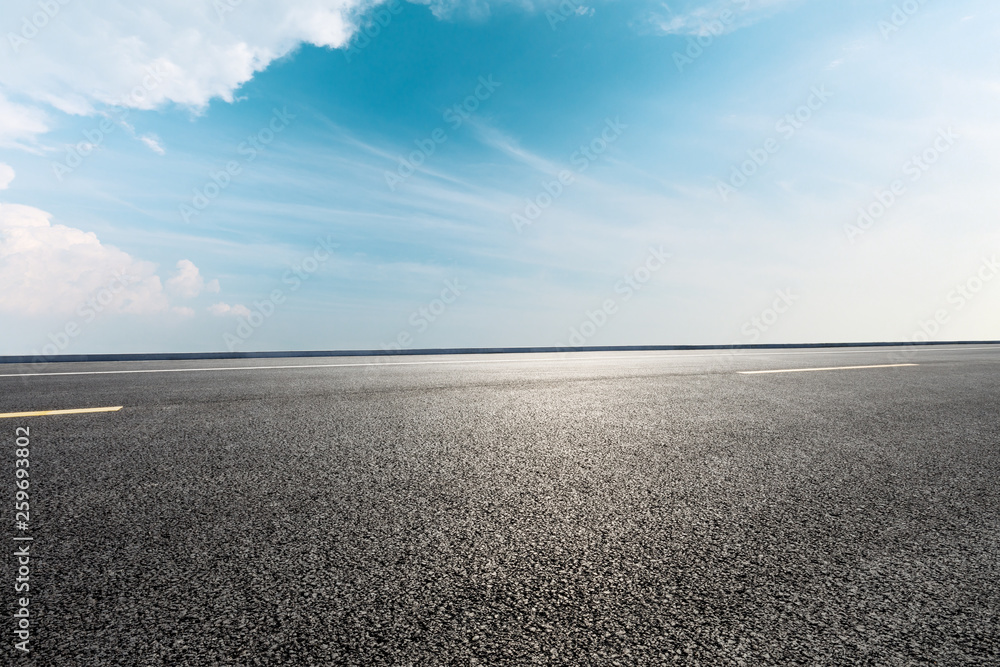 Empty asphalt road and blue sky with white clouds scene