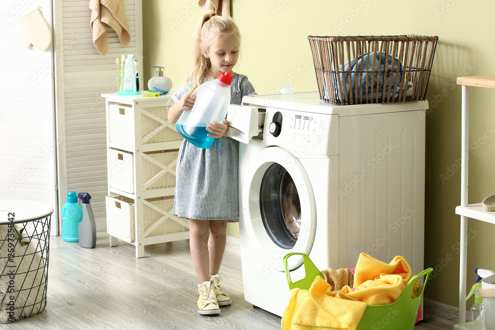 Little girl doing laundry at home