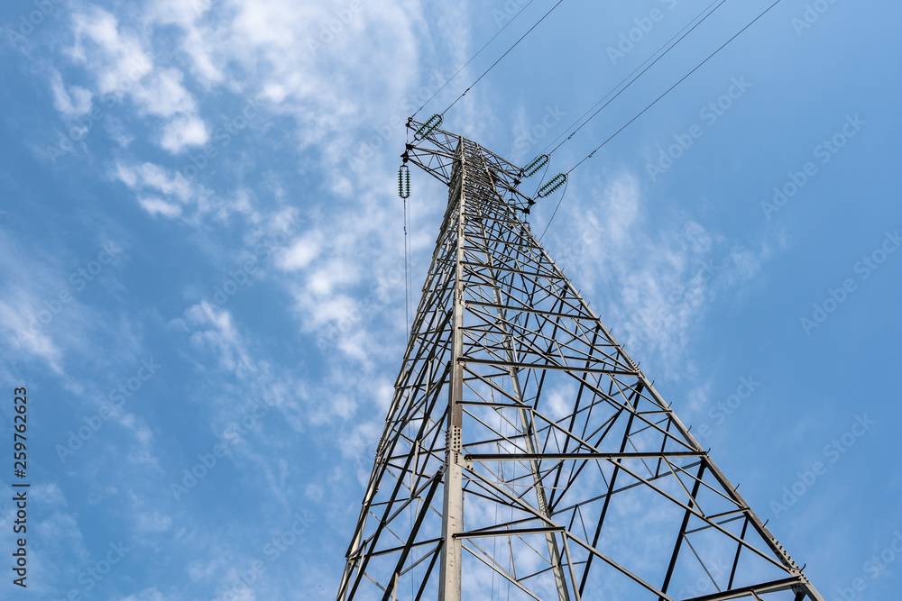 electricity pylon against blue sky