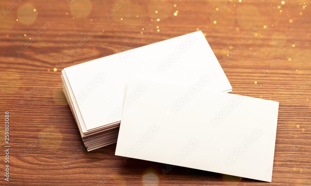 Blank white envelopes pile on wooden background