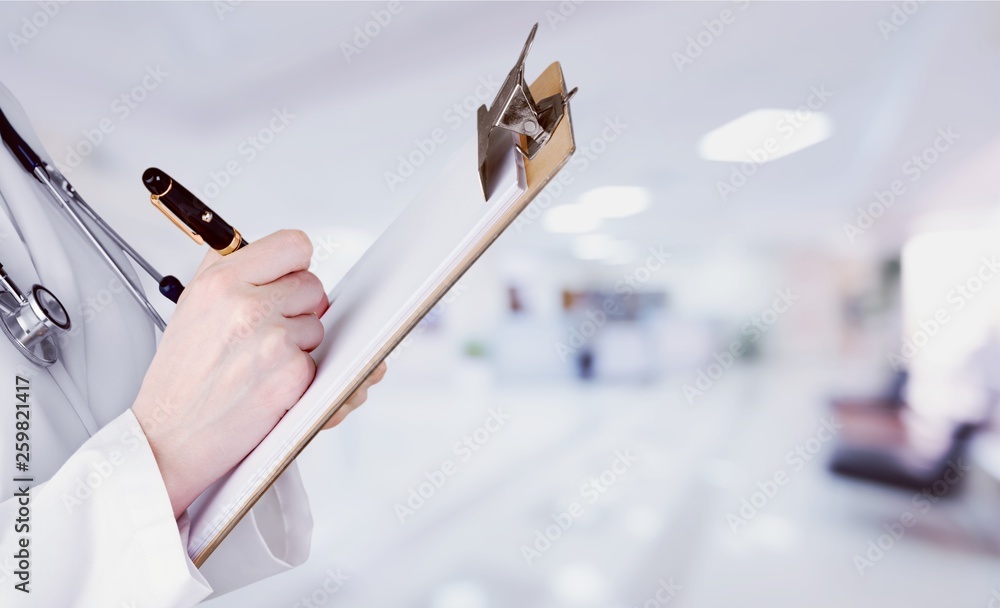 Young male doctor examining x-ray on white