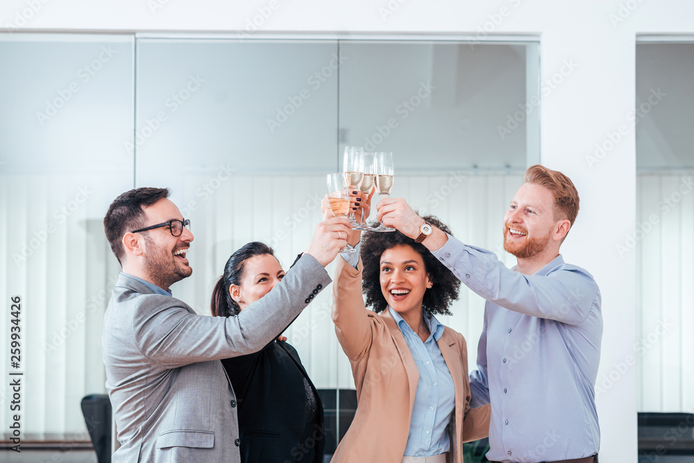 Business people celebrating success with glass of champagne.