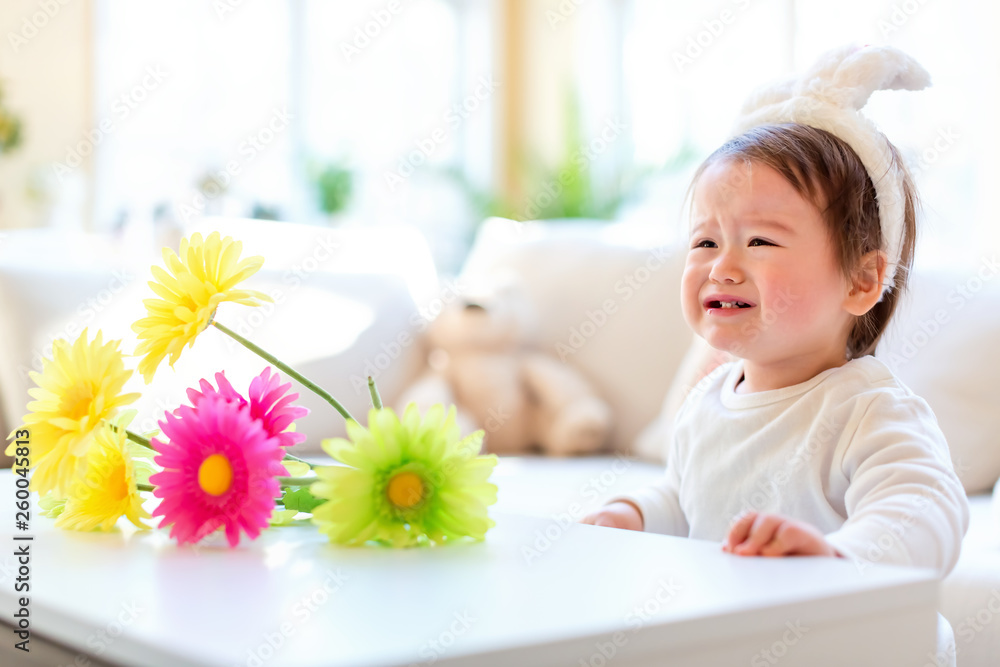 Crying toddler boy preparing for Easter Sunday