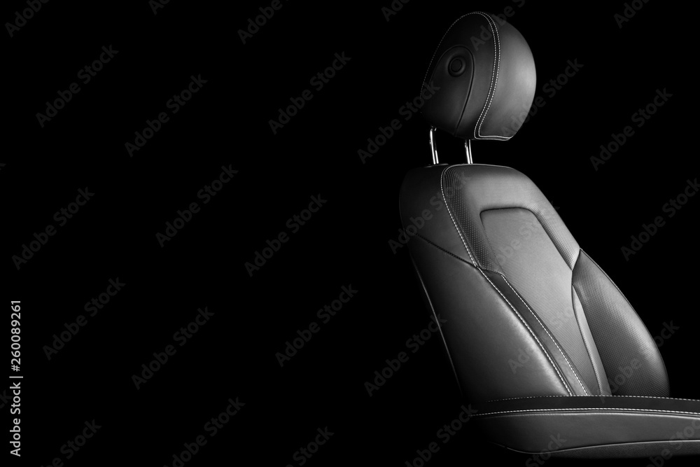 Modern luxury car leather interior. Part of leather car seat details with white stitching. Interior 