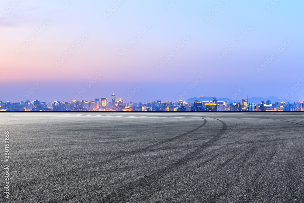 Asphalt race track ground and beautiful city scenery in Hangzhou at night