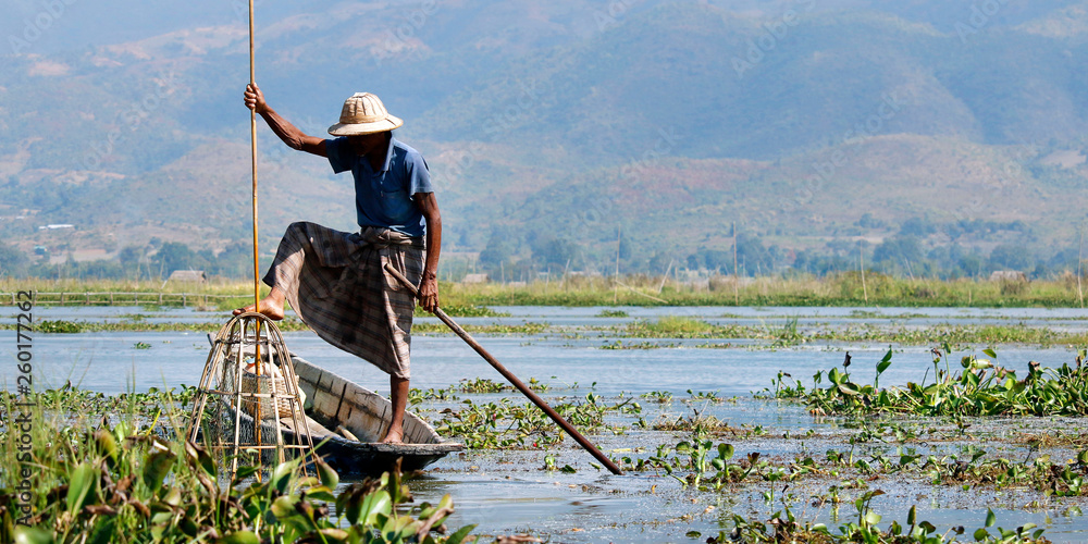 fisherman fishing with net on inle lake -myanmar