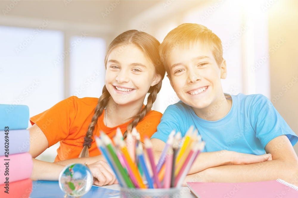 Friendly school children at school on background