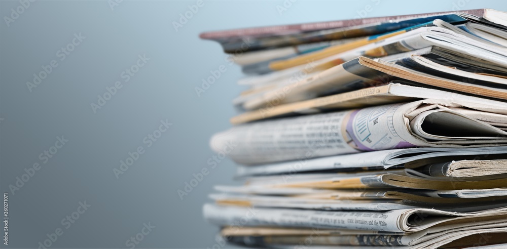 Pile of newspapers on white background