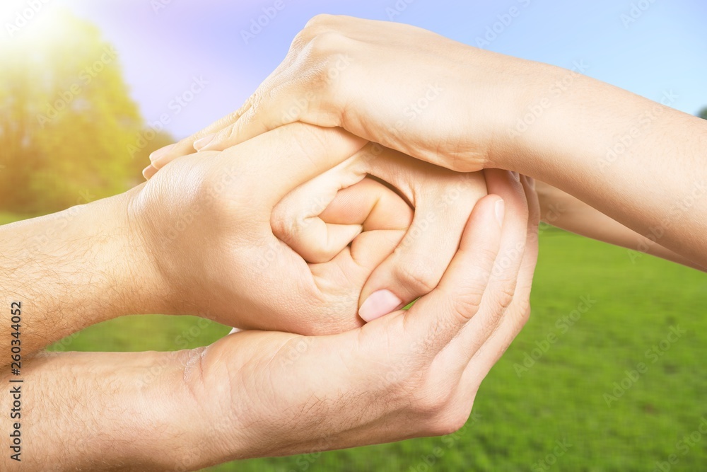 Group of people stacking hands together