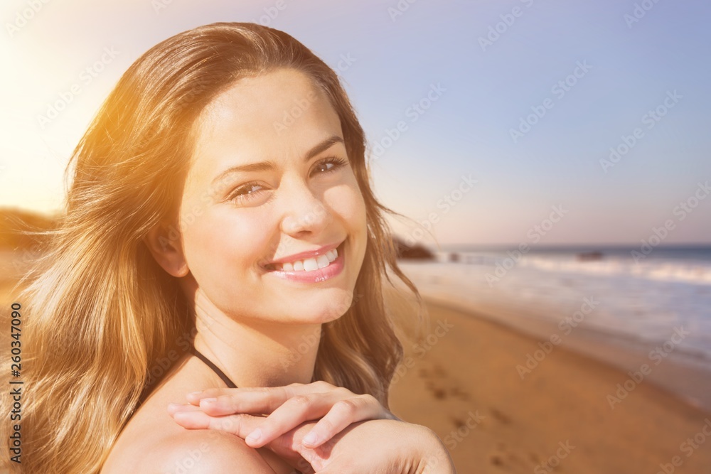 Outdoor summer portrait of pretty young smiling happy woman posing near the sea