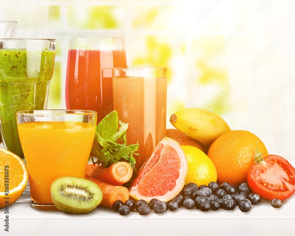 Tasty fruits  and juice with vitamins on background