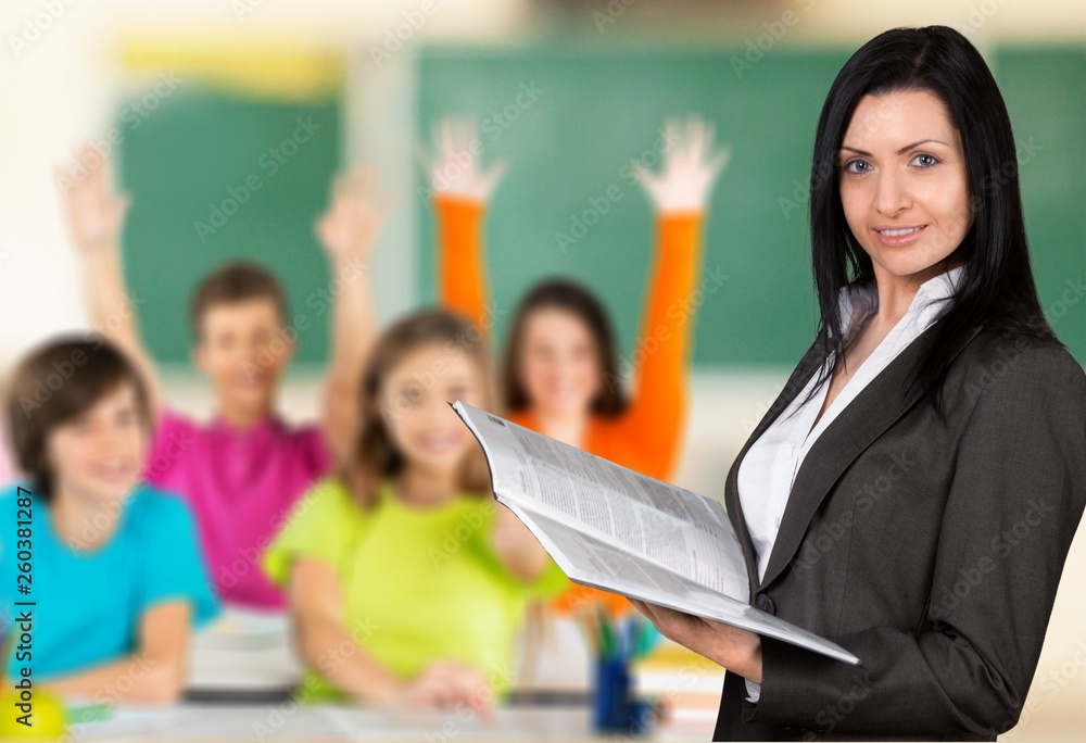 Female teacher with children at class on background