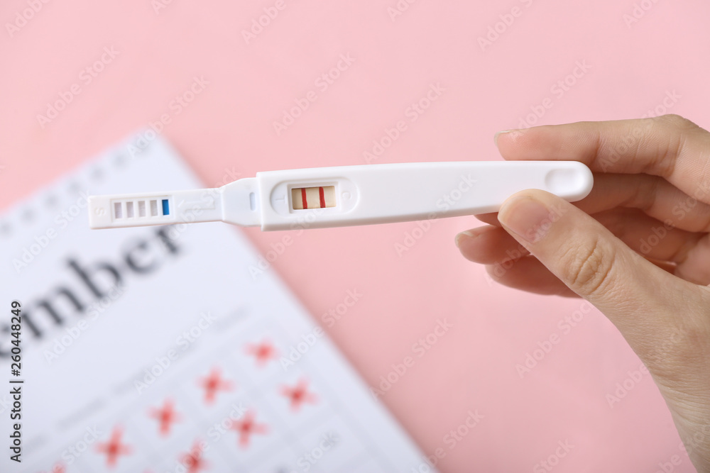 Female hand with pregnancy test