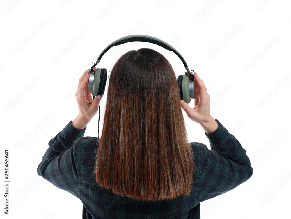 Young woman with headphones listening to music on white background