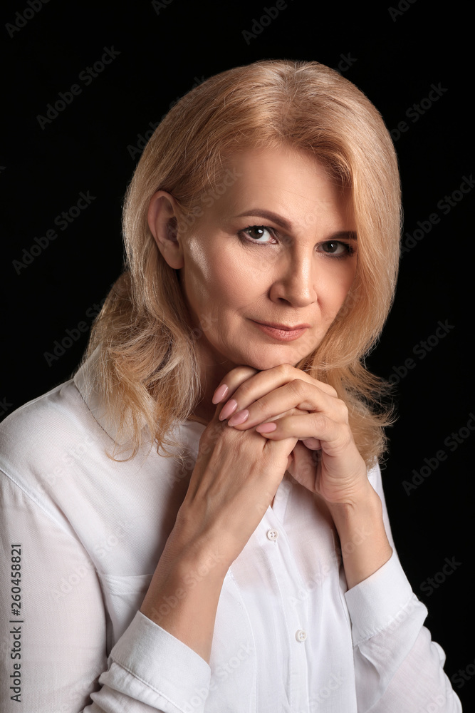 Stylish mature woman on dark background