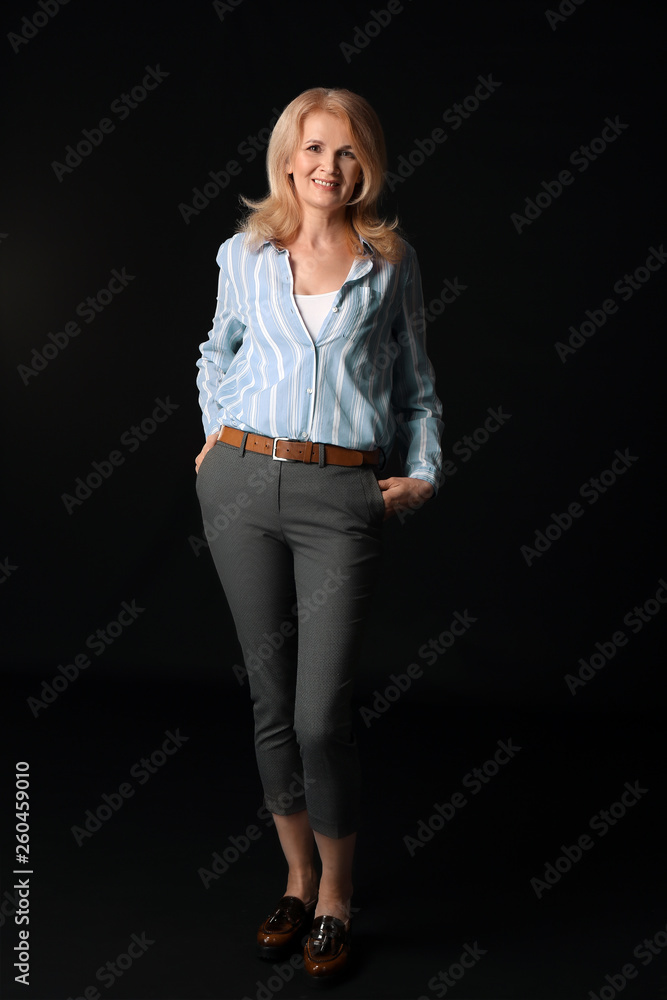 Stylish mature woman on dark background