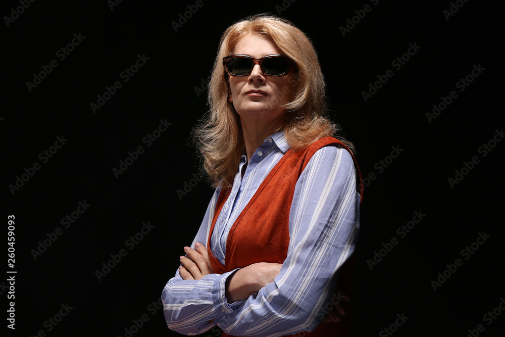 Stylish mature woman on dark background