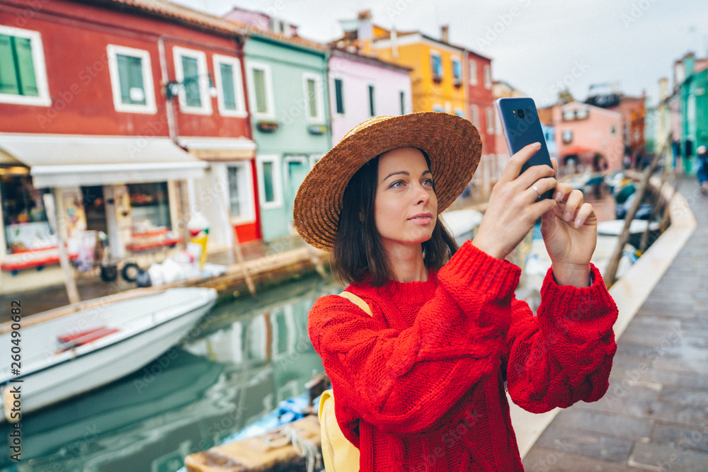 Beautiful tourist takes photos outdoors