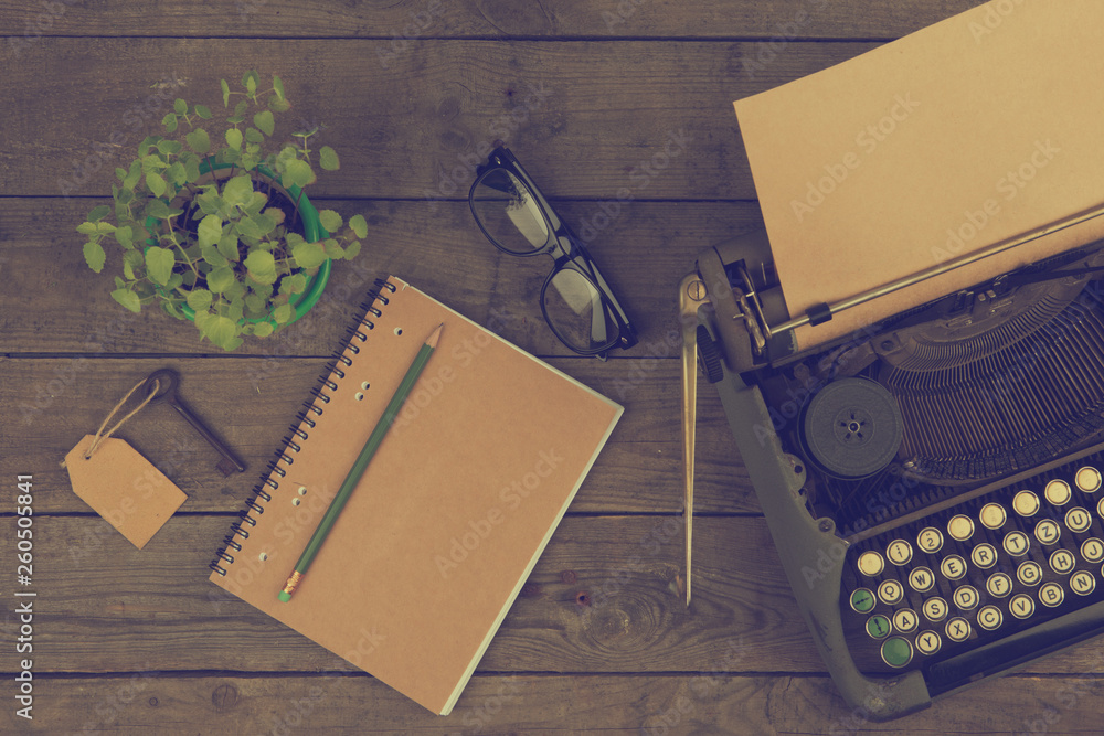 Vintage typewriter on the old wooden desk