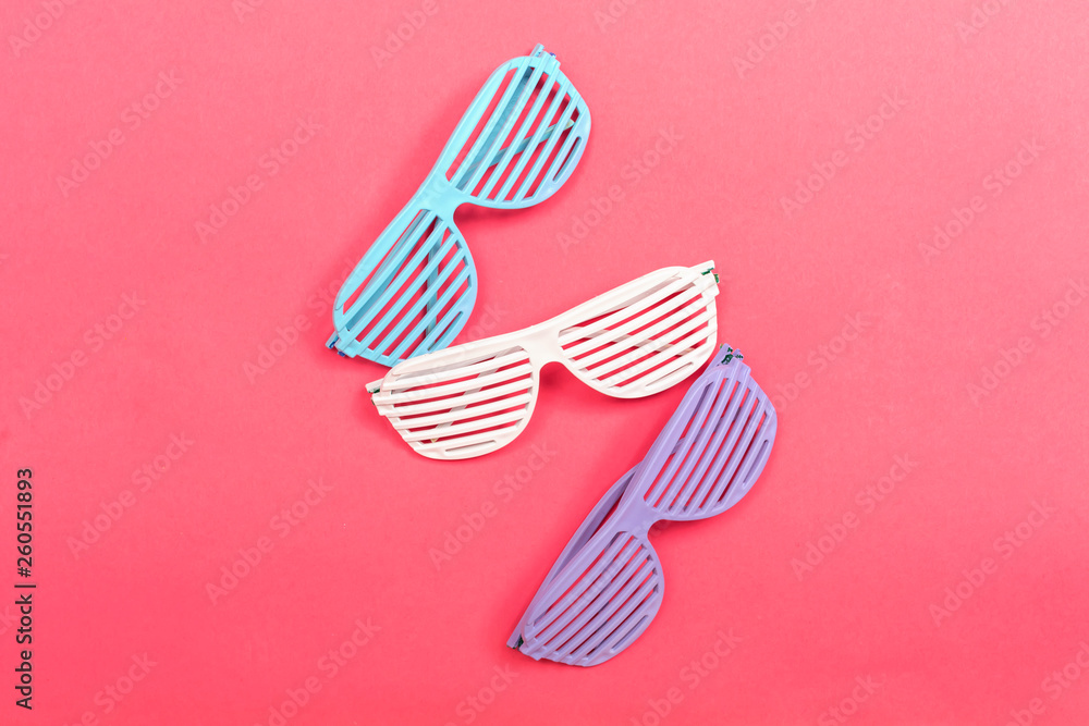 Shutter shade party glasses on a pink paper background