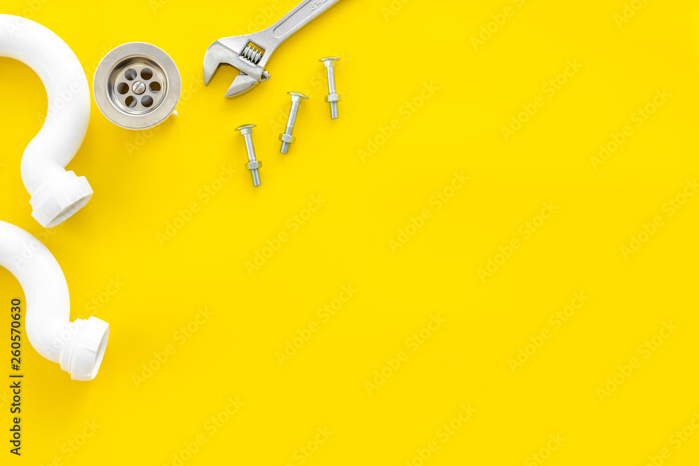 Plumber profession with gear and instruments for repair tubes on yellow background top view copyspac