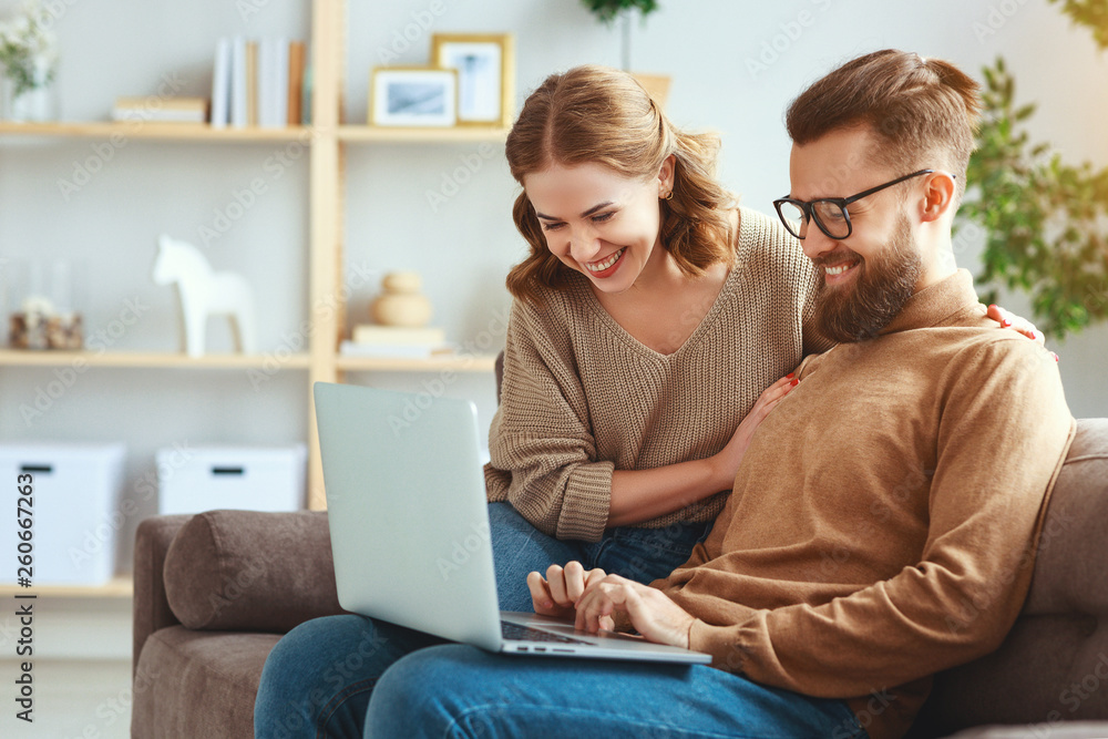 happy couple with laptop computer at home  .